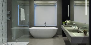 This image shows the master ensuite bathroom off the master bedroom in the art-filled minimalist apartment in Chelsea.