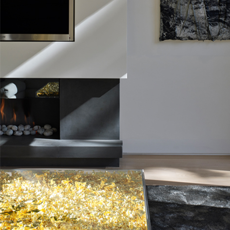 This image shows the fireplace in the living room of this minimalist art-filled apartment