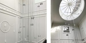 This image shows the wall panelling and skylight to the stairwell in this renovated historic townhouse in London.