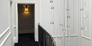 This image shows the staircase and Bocci chandelier in this renovated historic townhouse in London.
