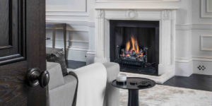 This image shows the reception room fireplace of this renovated, listed villa in St John's Wood, London.