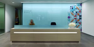 This image shows the reception desk for the new corporate office headquarters of a London investment firm.