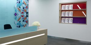 This image shows the reception desk and brochure stand for the new corporate office headquarters of a London investment firm.