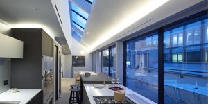 This image shows the kitchen, dining and terrace of one of the three luxury duplex apartments in Central London.
