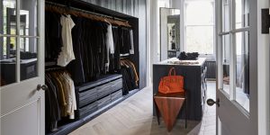 This image shows the refurbishment of the Little Venice, London historic property. It is the view of the new dressing room. You enter through an arched opening in the hall. The bespoke joinery was designed to fit all the client's wardrobe and shoes. This image exemplifies our modern approach to the design and refurbishment of historic properties in Europe.