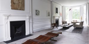This image shows the refurbishment of the Little Venice, London historic property. It is the view of the main reception room. We restored the wall panelling, refurbished the white marble fireplace and installed new oak flooring laid in a chevron pattern. The room features a beautiful bench by Brazilian designer Jorge Zalszupin. This image exemplifies our modern approach to the design and refurbishment of historic properties in Europe.
